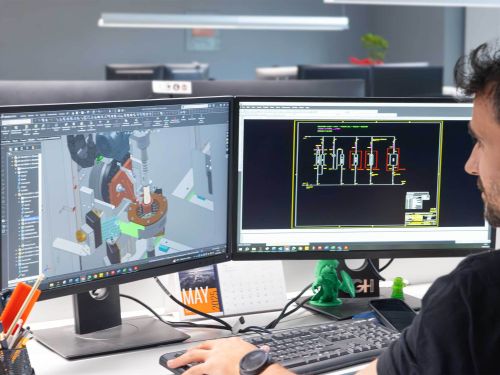 A person working on a computer using CAD software