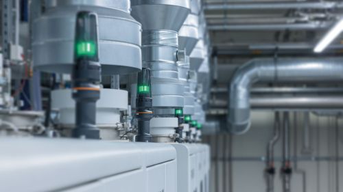 An illuminated green signal light on a crystal growing system.