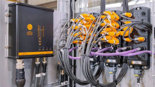 Several I/O modules have been fitted, with numerous cables visible.