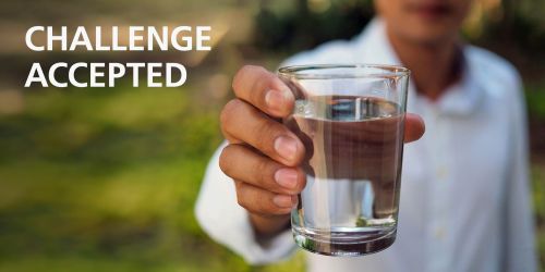 Challenge accepted! A hand holds a glass of pure water